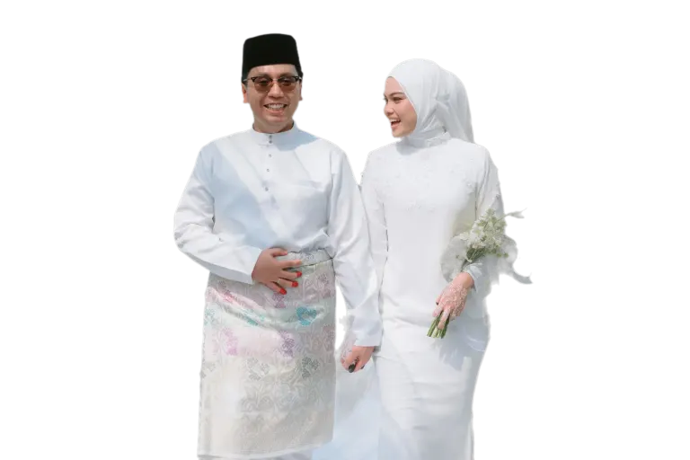 A Qura couple walking hand in hand in matching white nikah outfits